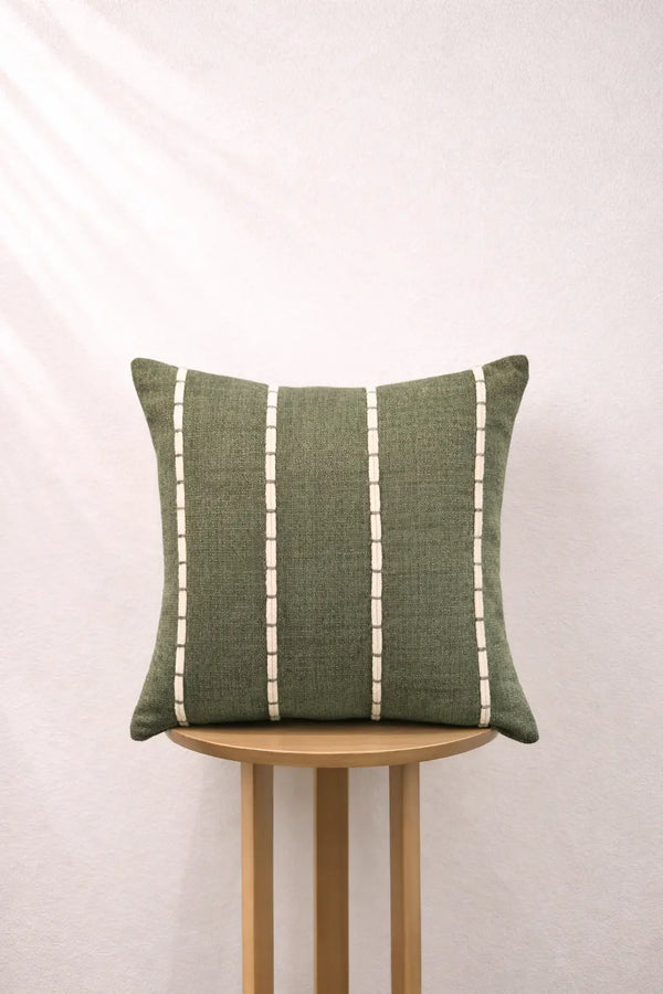 Moss Grey pillow with white stripes on a wooden stool against a light background